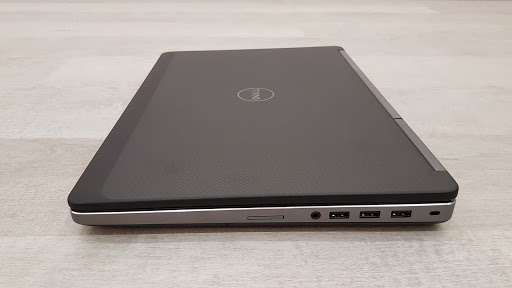 A black computer on a white surface Description automatically generated