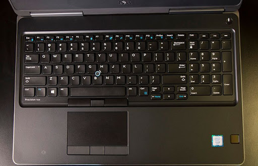A black computer with a touchpad Description automatically generated