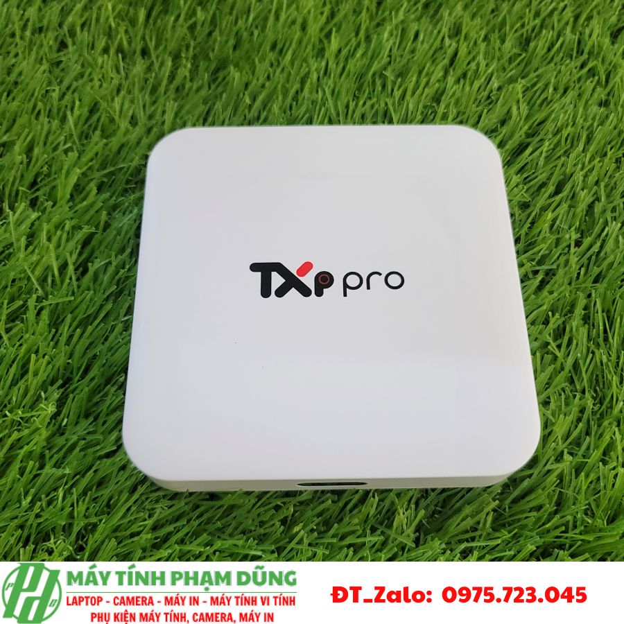 A white square device on grass Description automatically generated