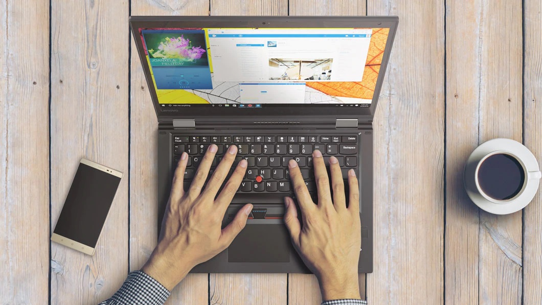 Hands on a computer keyboard Description automatically generated