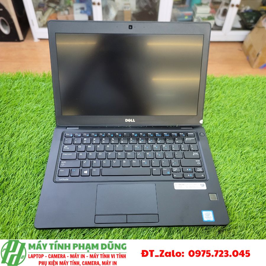 A computer on a grass surface Description automatically generated